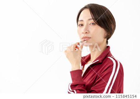 Woman in a jersey blowing a whistle Woman in a jersey blowing a whistle 115845154