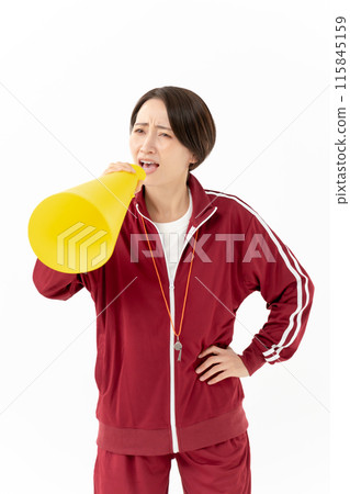 Woman in a jersey shouting into a megaphone 115845159