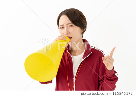 Woman in a jersey shouting into a megaphone Woman in a jersey shouting into a megaphone 115845172