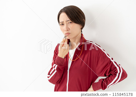 Woman in a jersey blowing a whistle 115845178