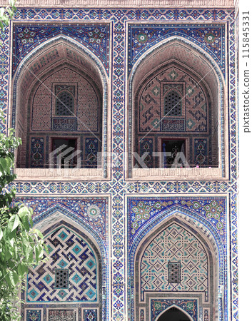 Famous landmark - Ulugh Beg Madrasah on Registan square, Samarkand, Uzbekistan. Arches with tile ornament in the courtyard of Ulugh Beg Madrasa 115845331