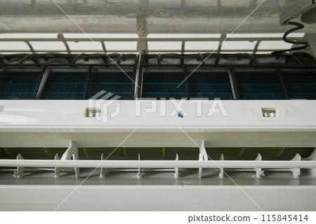 Air conditioner unit with opened front cover ready for maintenance 115845414