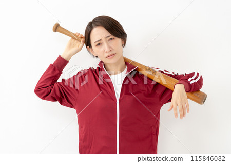 Woman in a jersey holding a bat 115846082