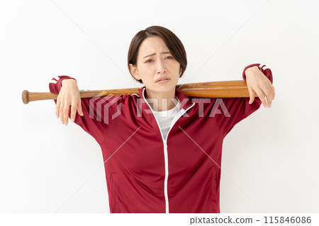 Woman in a jersey holding a bat 115846086