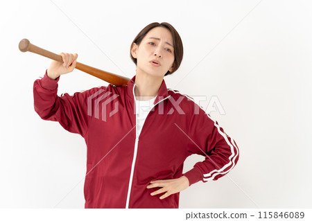 Woman in a jersey holding a bat 115846089