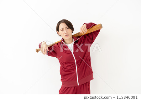 Woman in a jersey holding a bat 115846091
