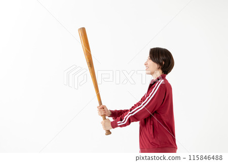 Woman in a jersey swinging a bat 115846488