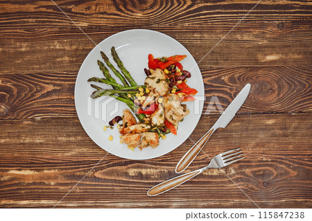 Overhead view of spicy chicken stew with vegetables and fried asparagus Overhead view of spicy chicken stew with vegetables and fried asparagus 115847238