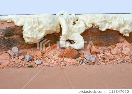 Construction foam. Installation of a metal plastic window,door,brick wall.  115847650