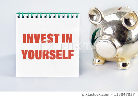Invest in yourself symbol. Concept words INVEST IN YOURSELF on a notebook with a piggy bank next to it Invest in yourself symbol. Concept words INVEST IN YOURSELF on a notebook with a piggy bank next to it 115847837
