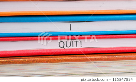 Business text. I Quit word close-up on the ends of the notebooks 115847854