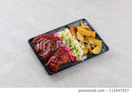 Close up Gourmet Main Dish with Grilled Pork Rib and Fried Potatoes on White Plate. Served on Wooden Table. Close up Gourmet Main Dish with Grilled Pork Rib and Fried Potatoes on White Plate. Served on Wooden Table. 115847937