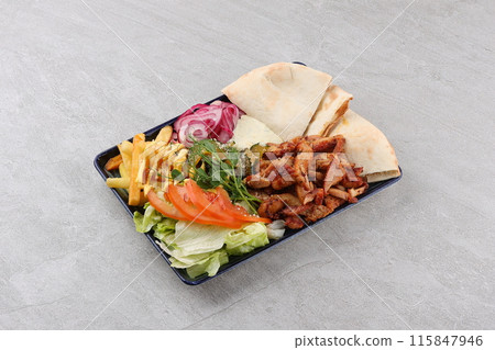Gyros, chicken, with vegetables on plates, disassembled shawarma, fast food, appetizer, cooking 115847946