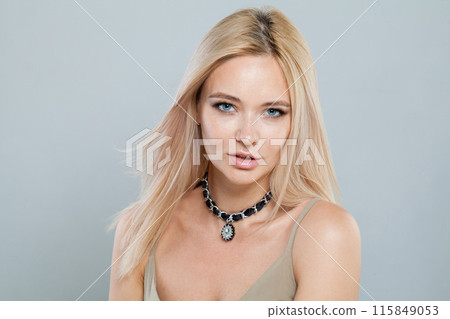 Posing young blonde lady with fresh clear skin and long smooth straight hairstile 115849053