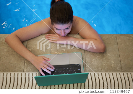 Woman Working on Laptop by Poolside Woman Working on Laptop by Poolside 115849467