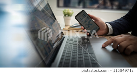 business intelligence business financial man hold smartphone use pc at workplace Financial growth business intelligence business financial man hold smartphone use pc at workplace Financial growth 115849712