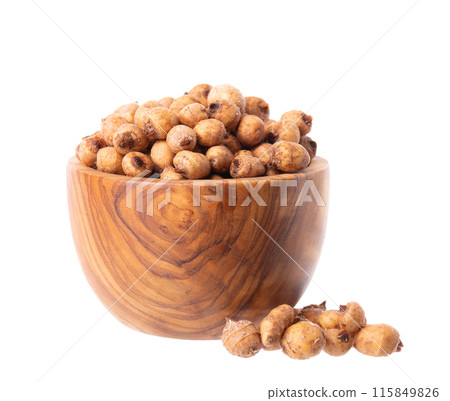 Tiger nuts in wooden bowl, isolated on white background. Pile of chufa nuts, earth almond or chufa sedge. Cyperus esculentus. Tiger nuts in wooden bowl, isolated on white background. Pile of chufa nuts, earth almond or chufa sedge. Cyperus esculentus. 115849826