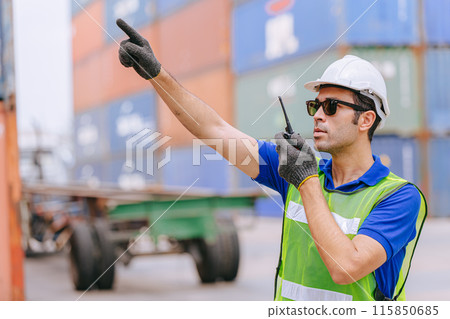Hispanic male port cargo shipping worker working radio control operate in port cargo shipping customs container yard. Hispanic male port cargo shipping worker working radio control operate in port cargo shipping customs container yard. 115850685