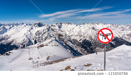 Panoramic view of winter snowy mountains and no fly zone sign. drone prohibition concept Panoramic view of winter snowy mountains and no fly zone sign. drone prohibition concept 115850786