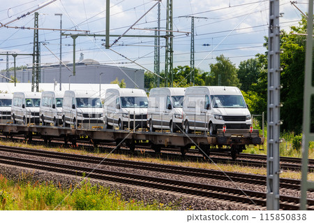 Many new modern electric and fuel cars vans transportation by cargo freight train railway wagon. Railroad export and import automotive logistics service. Safety and insurance goods shipping industry Many new modern electric and fuel cars vans transportation by cargo freight train railway wagon. Railroad export and import automotive logistics service. Safety and insurance goods shipping industry 115850838