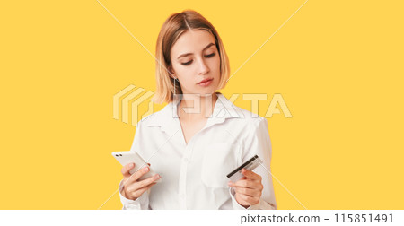 Online transaction. Internet purchase. Personal data safety. Confused client. Puzzled woman entering banking information isolated on yellow empty space. Online transaction. Internet purchase. Personal data safety. Confused client. Puzzled woman entering banking information isolated on yellow empty space. 115851491