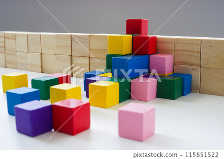 Allyship and teamwork concept. Colored cubes overcome the obstacle. 115851522