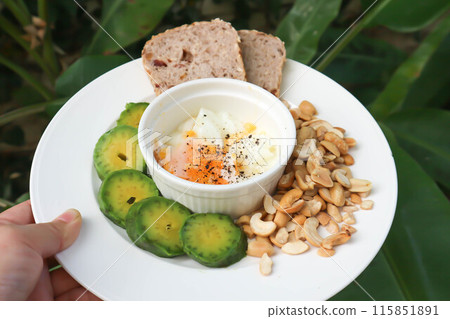 whole wheat bread or sourdough bread with nuts and soft boiled egg 115851891