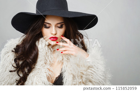 Elegance young adult woman fashion model with bright make-up and long wavy hair Elegance young adult woman fashion model with bright make-up and long wavy hair 115852059