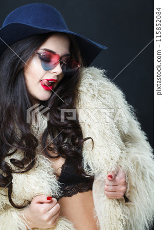 Beauty portrait of young adult woman fashion model with bright make-up and long wavy hair  115852084