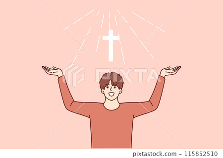 Man with christian cross above head rejoices at light coming from heaven and calls to pray 115852510