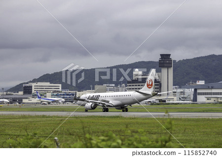 Passenger plane, airplane, J-AIR Embraer 190 landing at Osaka Airport and Itami Airport in the rain 115852740