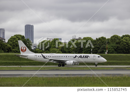 Scenery of Osaka Airport and Itami Airport in the rain, passenger plane taxiing, airplane, J-AIR Embraer 190 115852745
