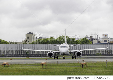 Scenery of Osaka Airport and Itami Airport in the rain, passenger plane taxiing, airplane, J-AIR Embraer 190 Scenery of Osaka Airport and Itami Airport in the rain, passenger plane taxiing, airplane, J-AIR Embraer 190 115852749