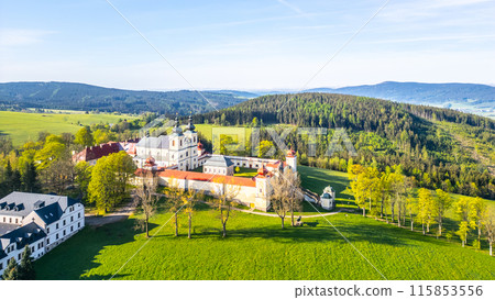 Hora Matky Bozi Monastery in Dolni Hedec, Czechia. The monastery is nestled on a hilltop overlooking the town and countryside. The photo showcases the unique architecture and the scenic landscape. 115853556