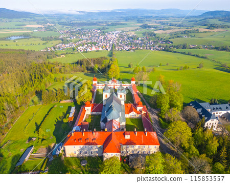 Hora Matky Bozi Monastery in Dolni Hedec, Czechia. The monastery is nestled on a hilltop overlooking the town and countryside. The photo showcases the unique architecture and the scenic landscape. 115853557