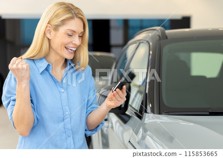 Blonde pretty woman in a dealership looking happy and excited Blonde pretty woman in a dealership looking happy and excited 115853665