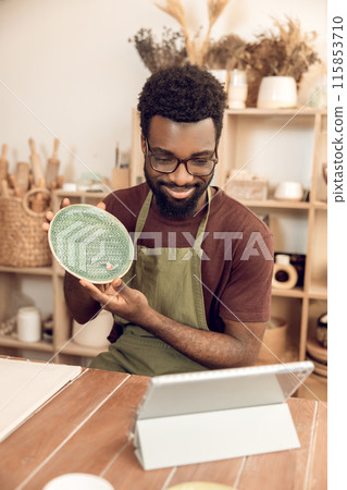 African american sculptor conducting a n online tutorial and looking contented 115853710
