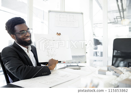 Smiling and successful dark-skinned businessman in his office 115853862