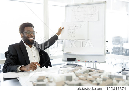 Contented and determined african american businessman making presentation of a new project Contented and determined african american businessman making presentation of a new project 115853874