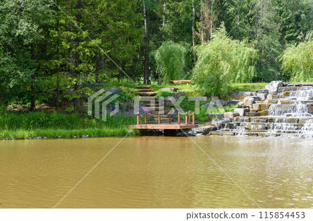 Landscape with cascading waterfall and stone staircase by the pier. Landscape with cascading waterfall and stone staircase by the pier. 115854453