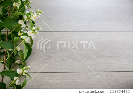 wooden light background with white jasmine flowers 115854483