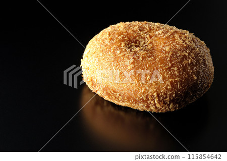 Curry bread photographed against a black background 115854642