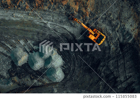 bright excavator at work on a dark background view from a drone 115855083