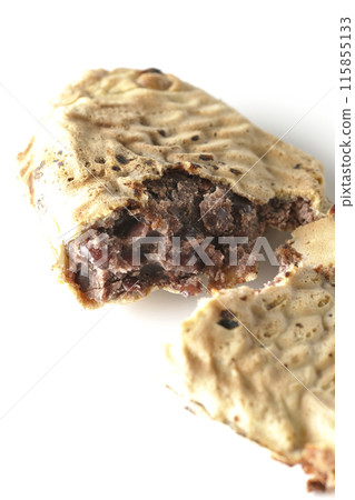 Broken thin-skinned taiyaki photographed on a white background Broken thin-skinned taiyaki photographed on a white background 115855133