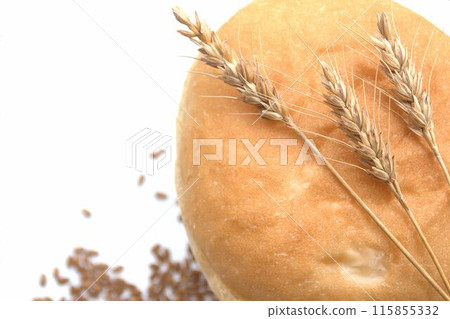 Round bread and wheat ears on white background 115855332