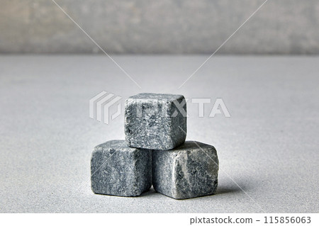 Three stone cubes on a gray concrete pillar. Mockup for presentation and sale of goods Three stone cubes on a gray concrete pillar. Mockup for presentation and sale of goods 115856063