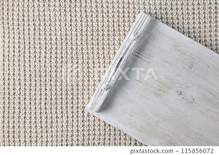 White wooden tray, cutting board on beige knit background. Top view with copy space 115856072