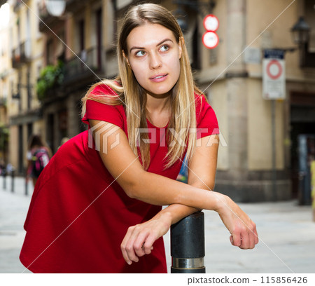 Beautiful girl walks through the old European streets 115856426