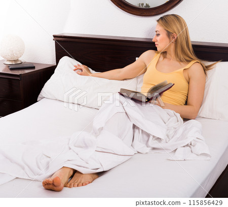 Blonde woman is sad one on bed 115856429