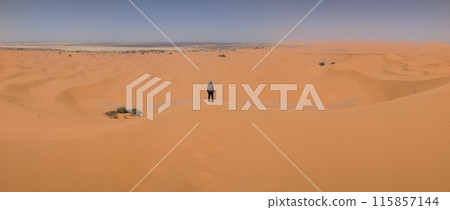 Hiking up the Great Dune of Merzouga in the Erg Chebbi desert, Moroccan Sahara Hiking up the Great Dune of Merzouga in the Erg Chebbi desert, Moroccan Sahara 115857144